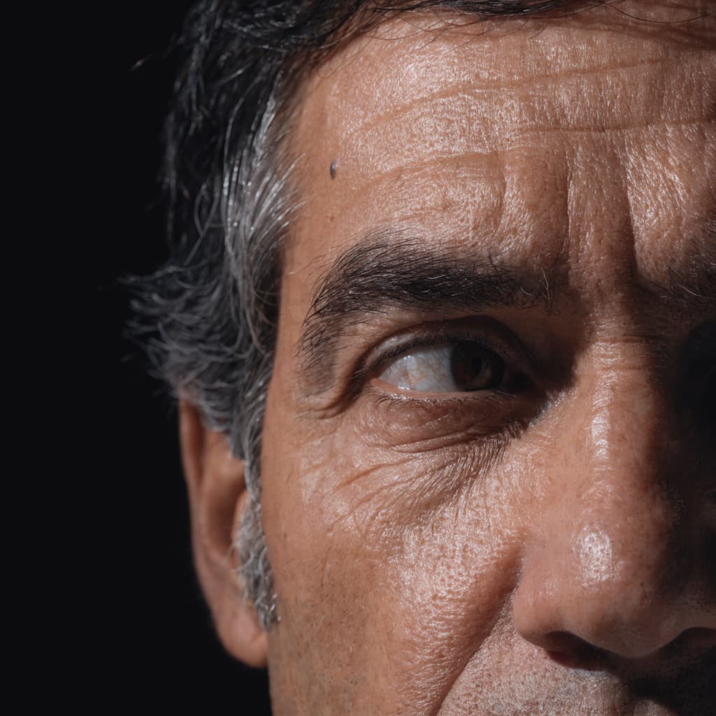Close-up of a man's eye area highlighting the eyelid region