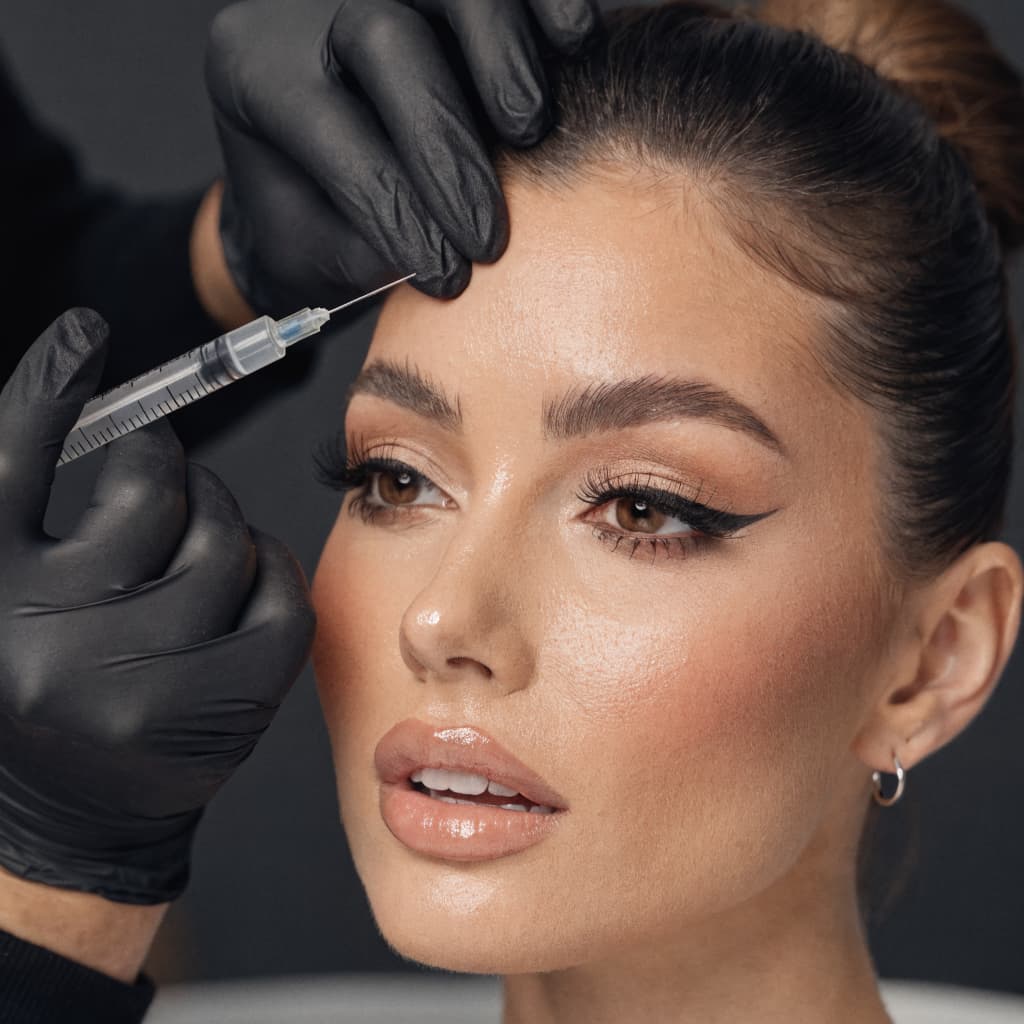 Woman receiving Botox injection treatment at a luxury medical spa